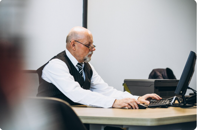 Senior professional working at a desk in an office
